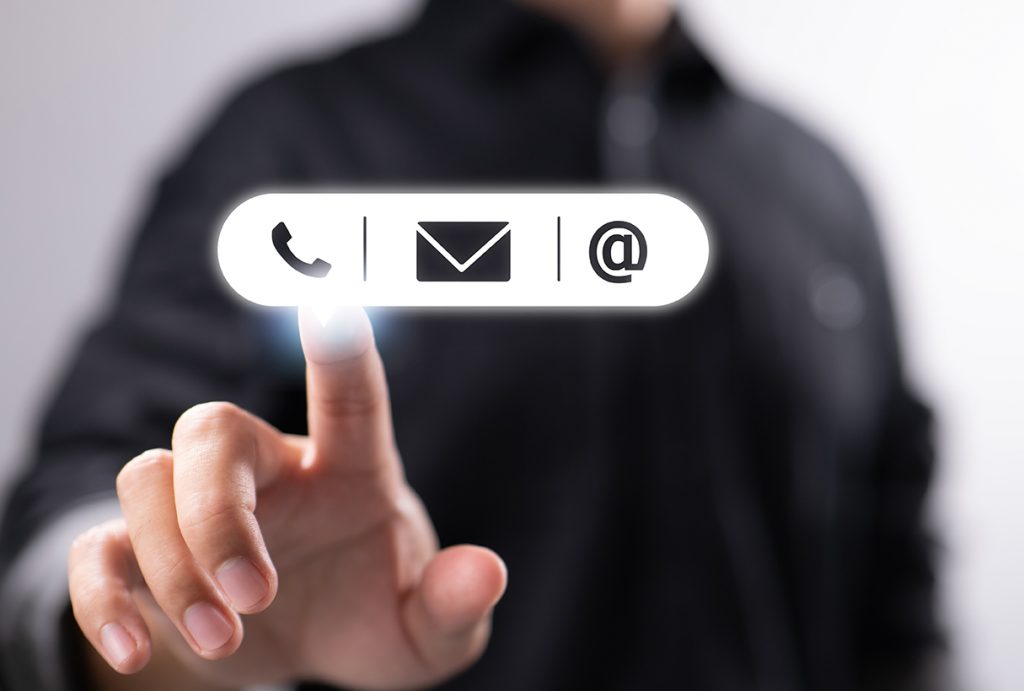 a businessman is seen pressing the icons for mail, phone, and ad